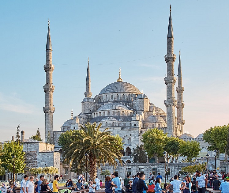 The Blue Mosque, a blue domed building with minarets, with tourists milling around in front