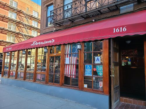 Photo of a restaurant with a red awning from the outside