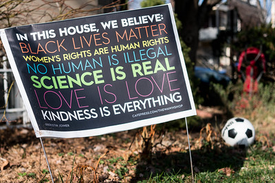 Photograph of the original design for the yard sign with slogans displayed in various colors and fonts