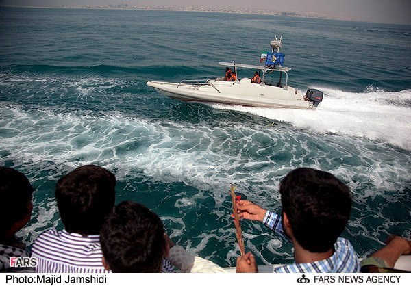 View from behind of relatives of victims of Flight 655, standing on the deck of a boat as they visit location of shoot-down